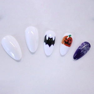 Long almond press-on nails with Halloween pumpkin, bat and spider web patterns