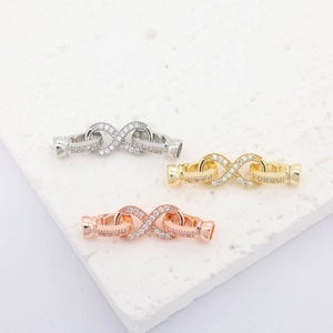 Detail of infinity charms in gold, silver, and rose gold with micro-pave cubic zirconia