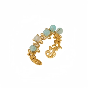 Gold star pattern steel ring with light blue and white beads in an open design