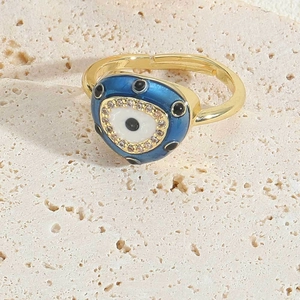 Detailed view of adjustable golden evil eye ring with blue enamel and sparkling zircon