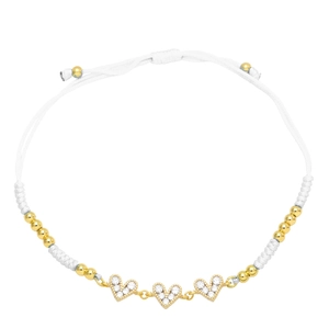 Close-up of handmade white braided bracelet with three cubic zirconia heart charms
