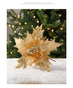 Detail of 26cm gold glitter Christmas flower with sequins on snow background