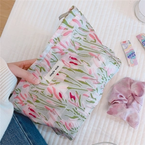 Close-up of pink floral jacquard fabric with woven texture and a simple wish label