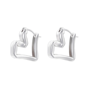 Close-up of asymmetrical heart-shaped silver hoop earrings with modern minimalist design