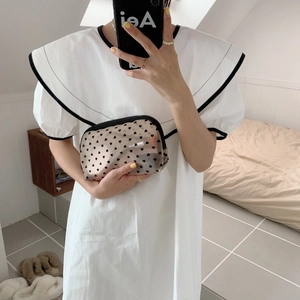 Detail of transparent heart mesh bag holding cosmetics with smooth zipper closure