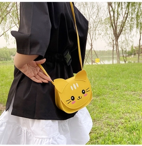 Detailed view of yellow cartoon cat crossbody bag with cute 3D ears and matching strap