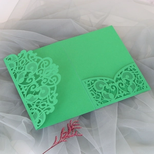 Detailed laser-cut pattern on green baroque style invitation sleeve with lace hollow design