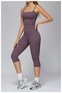 Close-up of deep purple yoga set with thin strap sports bra and high-waisted leggings
