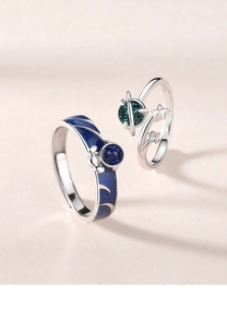 Close-up of S925 sterling silver astronaut couple rings with blue starry enamel detail