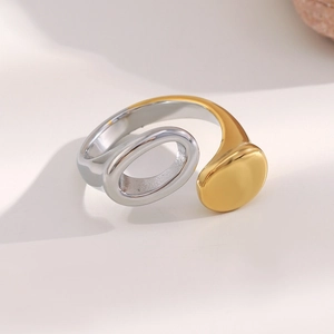 Detailed macro view of two-tone gold and silver minimalist open ring with mirror finish