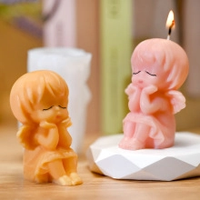 Close-up detail of angel scented candle molds in soft orange and pink colors