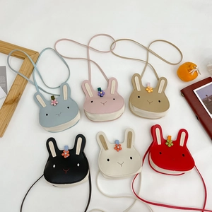 Flat lay of colorful rabbit-shaped mini crossbody bags in six vibrant colors for girls