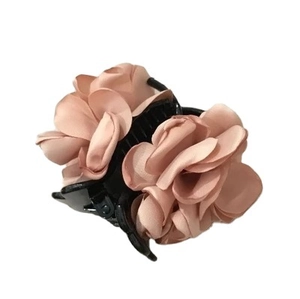 Pink fabric rose flower hair claw clip with black plastic base on white background