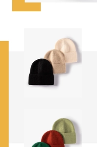 Close-up of assorted colorful knitted beanies showcasing the fine ribbed texture and fold-over cuff