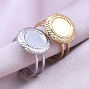 Macro detail of gold and silver minimalist rings with sunburst textures on purple silk