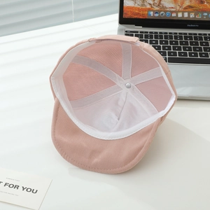 Detailed view of the soft pink corduroy baby cap interior with reinforced white lining