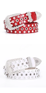 Detail of rhinestone studded faux leather belts with crocodile pattern in red and white