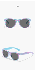 Detail view of light blue kids sunglasses with pink watermelon patterns and grey lenses