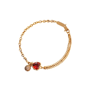 Elegant gold plated chain bracelet featuring a red heart gemstone and textured gold bead