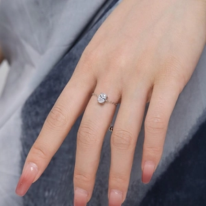 Detail of adjustable chain ring with oval zircon on a hand with nude nails