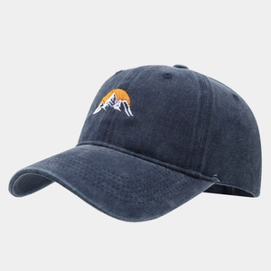 Detail of sunrise and mountain embroidery on washed charcoal cotton baseball cap