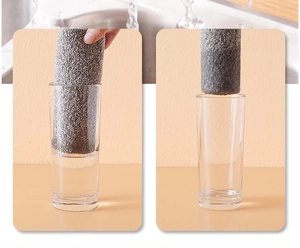 Close-up showing the high absorption capacity of a grey charcoal fiber kitchen cloth