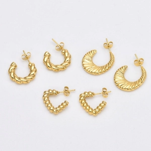 Detailed view of three pairs of 18K gold-plated stainless steel C-shaped earrings