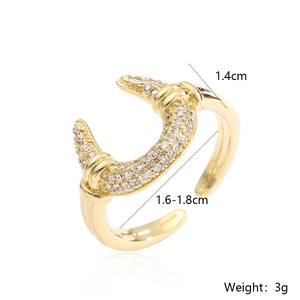 Macro view of gold plated geometric ring featuring white zircons and dimensions of 1.4cm