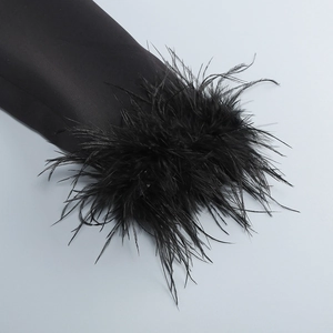 Detail of elegant black blazer sleeve featuring thick and fluffy feather cuff trim decoration