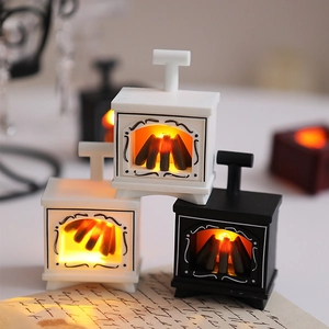 Close-up of vintage mini LED fireplaces in black and white for Christmas home decor