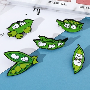 Detailed view of five creative green pea pod cat enamel pins on a blue and white background
