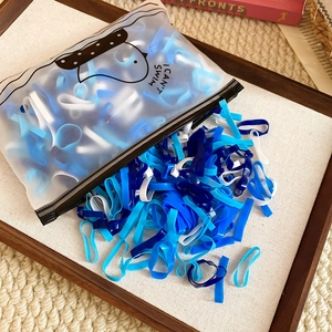 Elastic hair ties in blue and white, stored in a translucent matte zipper bag