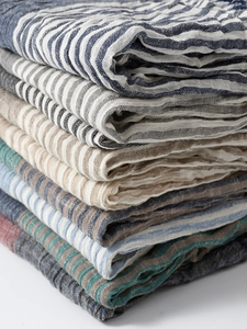 Close-up of lightweight navy striped cotton-linen blend fabric layers for men's scarves