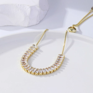 Detail of adjustable gold bolo bracelet with marquise-cut sparkling zircon stones
