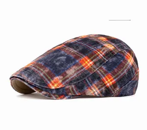 Detailed view of the classic blue and orange plaid beret with woven wool texture