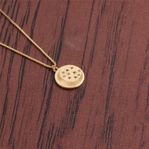 Collier doré lune et étoile avec pierres précieuses sur fond en bois sombre