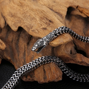 Macro detail of antique silver snake head clasp on double-row titanium steel bracelet