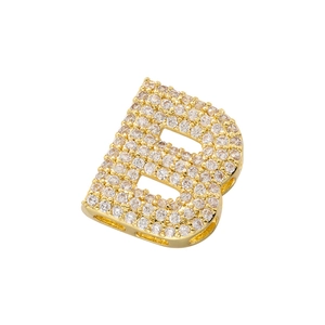 Macro shot of gold-plated letter B pendant with micro-pave cubic zirconia inlay