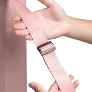 Detailed close-up of pink nylon yoga mat strap with adjustable black plastic buckle
