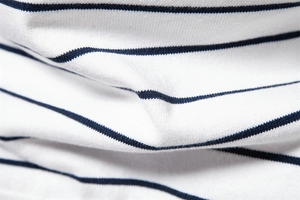 Close-up of the premium navy blue and white striped knit fabric and texture for men