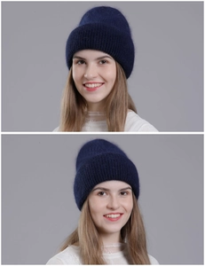 Detail view of navy blue rabbit fur knit hat showing thick plush texture and warm ear protection
