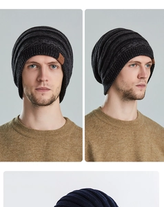 Detail of knitted beanie showing thick texture and brown leather patch accent on the cuff