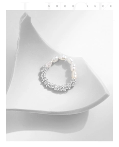 Detailed view of elastic S925 sterling silver ring with pearl on minimalist tray