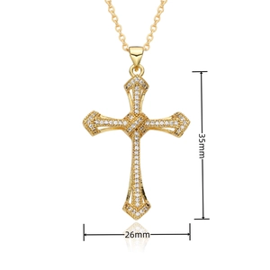 Detailed view of a gold cross pendant with micro-pave cubic zirconia, 35mm by 26mm
