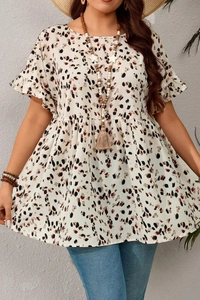 Detail of plus size summer top with leopard print and ruffled sleeves on cream fabric
