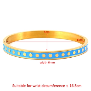 Detail of blue enamel bangle with gold dots showing 5cm by 6cm inner diameter dimensions