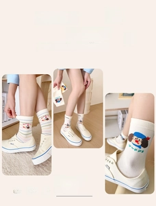Detail of dachshund patterned cotton socks featuring colorful stripes and high-quality double knitting