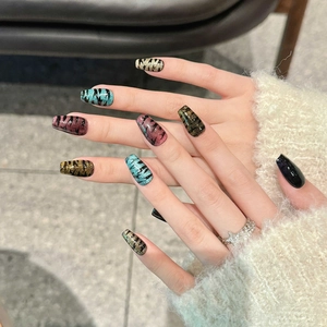 Handmade Halloween coffin nails with cat eye shimmer and tiger stripe patterns