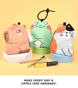 Close-up of cute cartoon coin purses featuring capybara and cat designs with zipper