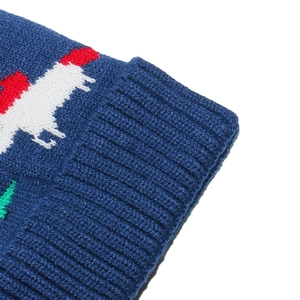 Close-up of blue knitted winter hat showing ribbed texture and jacquard pattern detail